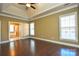 Well lit bedroom with hardwood floors and access to bathroom at 7757 St Andrews Ln, Stanley, NC 28164