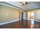 Bright bedroom with hardwood floors, access to bathroom and ensuite bathroom at 7757 St Andrews Ln, Stanley, NC 28164