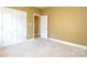 Well-lit bedroom featuring neutral walls and carpet flooring at 7757 St Andrews Ln, Stanley, NC 28164