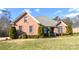 Brick home with landscaped lawn and mature trees at 7757 St Andrews Ln, Stanley, NC 28164