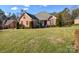 Landscaped lawn and brick home with driveway at 7757 St Andrews Ln, Stanley, NC 28164