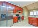 Stainless steel appliances and ample wood cabinets in kitchen at 7757 St Andrews Ln, Stanley, NC 28164