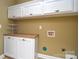 Laundry room with upper cabinets and built-in storage at 7757 St Andrews Ln, Stanley, NC 28164