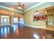 Bright living room with hardwood floors and view into kitchen at 7757 St Andrews Ln, Stanley, NC 28164