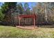 Red wooden pergola in a backyard setting at 7757 St Andrews Ln, Stanley, NC 28164