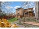 Backyard with wooden deck, steps leading to patio, and yellow chairs at 8149 Mattingridge Dr, Charlotte, NC 28270