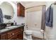 Bathroom with dark wood vanity, bathtub, and dark tile flooring at 8149 Mattingridge Dr, Charlotte, NC 28270