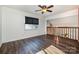 Bright bedroom featuring dark laminate wood flooring and a window with blinds at 8149 Mattingridge Dr, Charlotte, NC 28270