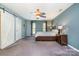 Main bedroom with ceiling fan, large windows, and sliding barn door at 8149 Mattingridge Dr, Charlotte, NC 28270