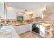 Bright kitchen with white cabinets, tile countertops, and stainless steel appliances at 8149 Mattingridge Dr, Charlotte, NC 28270