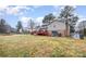 Large backyard with a wooden deck, brick chimney, and ample space for recreation at 939 Malotte Ln, Gastonia, NC 28054