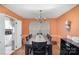 Dining room with a dark wood table and black chairs, adjacent to kitchen at 939 Malotte Ln, Gastonia, NC 28054