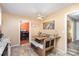 Eat in kitchen with a bench table and a view into the orange dining room at 939 Malotte Ln, Gastonia, NC 28054