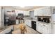 Well-lit kitchen featuring white cabinetry, stainless steel appliances and breakfast nook seating at 939 Malotte Ln, Gastonia, NC 28054