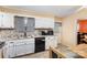 Kitchen view featuring white cabinets, mosaic backsplash, and breakfast nook at 939 Malotte Ln, Gastonia, NC 28054