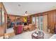 Wood paneled living room with comfortable leather seating and brick fireplace at 939 Malotte Ln, Gastonia, NC 28054