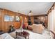 Cozy living room with wood paneled walls, brick fireplace, and comfortable leather furniture at 939 Malotte Ln, Gastonia, NC 28054