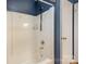 Shower area with white tiling and chrome fixtures in a bathroom with navy walls at 939 Malotte Ln, Gastonia, NC 28054