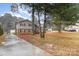 A charming two-story home with a spacious front yard and mature trees at 939 Malotte Ln, Gastonia, NC 28054