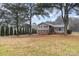 A home with a spacious front yard featuring mature trees and lush greenery at 939 Malotte Ln, Gastonia, NC 28054