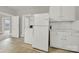 White appliances and cabinets in this galley kitchen at 951 Cedar St, Rock Hill, SC 29730