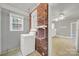 Laundry room with brick accent wall and shelving at 951 Cedar St, Rock Hill, SC 29730