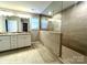 Modern bathroom with dual vanities, granite countertops, and a walk-in tiled shower with a glass enclosure at 9831 Quercus Ln, Huntersville, NC 28078