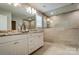 Modern bathroom featuring double vanity, large mirror, tiled walls, and a spacious shower area at 9831 Quercus Ln, Huntersville, NC 28078