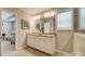 Bathroom features a double sink vanity with granite counters and a view into an adjacent sitting room at 9831 Quercus Ln, Huntersville, NC 28078