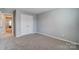 A bedroom with neutral carpet and gray walls at 9831 Quercus Ln, Huntersville, NC 28078