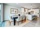 Modern dining room open to a bright kitchen with white cabinetry and a central island at 9831 Quercus Ln, Huntersville, NC 28078