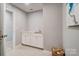 A laundry room with a sink, cabinets, and doorway at 9831 Quercus Ln, Huntersville, NC 28078