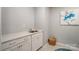 A laundry room with a sink, cabinets, and white walls at 9831 Quercus Ln, Huntersville, NC 28078