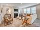 Bright living room featuring a fireplace, large windows, stylish furniture, and modern decor at 9831 Quercus Ln, Huntersville, NC 28078