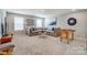 Inviting living room area featuring a sectional sofa, contemporary decor, and a foosball table for recreation at 9831 Quercus Ln, Huntersville, NC 28078