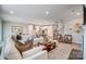 Spacious living room flowing into a bright, modern kitchen and dining area with stylish decor at 9831 Quercus Ln, Huntersville, NC 28078