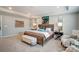 Elegantly furnished bedroom featuring a tray ceiling, neutral color palette, and ample natural light from large windows at 9831 Quercus Ln, Huntersville, NC 28078