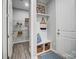 A mudroom with a small bench, overhead shelving, coat hooks, and access to pantry at 9831 Quercus Ln, Huntersville, NC 28078