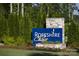 Community sign for Roseshire Chase surrounded by lush greenery, flowers, and manicured landscaping at 9831 Quercus Ln, Huntersville, NC 28078