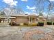 Rear view of brick house with covered patio and mature landscaping at 10140 Steele Creek Rd, Charlotte, NC 28273