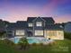 Stunning home with pool and landscaped yard at dusk at 11112 Benjamin Smith Ave, Huntersville, NC 28078