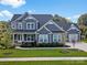 Two-story home with gray siding, large windows, and a welcoming porch at 11112 Benjamin Smith Ave, Huntersville, NC 28078