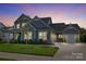 Two-story home with gray siding, stone accents, and a landscaped yard at 11112 Benjamin Smith Ave, Huntersville, NC 28078