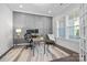 Home office with gray wall paneling, built-in desk, and large windows at 11112 Benjamin Smith Ave, Huntersville, NC 28078