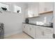 Laundry room with white cabinets, black countertops, and a washer and dryer at 11112 Benjamin Smith Ave, Huntersville, NC 28078