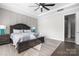 Main bedroom with hardwood floors, large bed, and access to en-suite bathroom at 11112 Benjamin Smith Ave, Huntersville, NC 28078