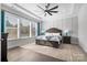 Spacious main bedroom with hardwood floors, large windows, and a ceiling fan at 11112 Benjamin Smith Ave, Huntersville, NC 28078