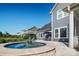 Circular hot tub with stone border next to home and pool at 11112 Benjamin Smith Ave, Huntersville, NC 28078