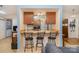 Small kitchen with breakfast bar and wood cabinets at 11900 Musket Ln, Charlotte, NC 28273