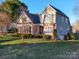 Two-story house with brick and siding, showcasing a side view of the home and yard at 125 Musketball Ct, Indian Trail, NC 28079